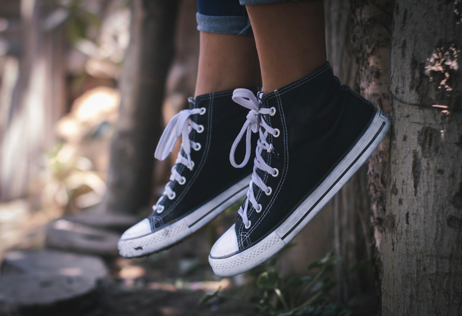 person in black-and-white high-top sneakers